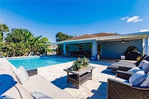 pool with ceiling fan, a patio, and outdoor lounge area