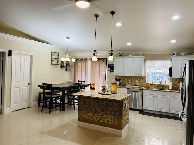 kitchen featuring a kitchen island, white cabinetry, hanging light fixtures, freestanding refrigerator, and dishwasher