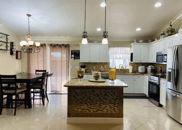 kitchen featuring stainless steel appliances, white cabinets, a kitchen island, and hanging light fixtures