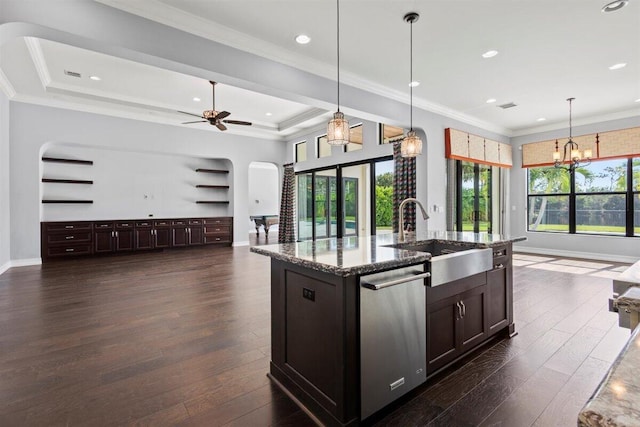 kitchen featuring arched walkways, dishwasher, dark wood-style floors, open floor plan, and a sink