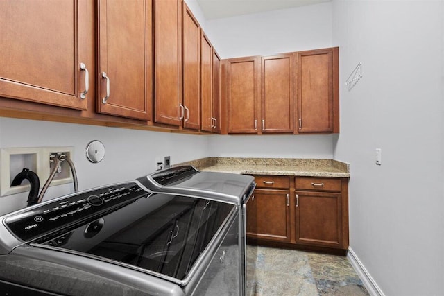 laundry area featuring cabinet space, baseboards, and washer and dryer