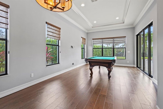 playroom with ornamental molding, a raised ceiling, baseboards, and wood finished floors