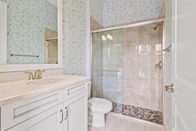 full bathroom with toilet, wallpapered walls, vanity, and a stall shower