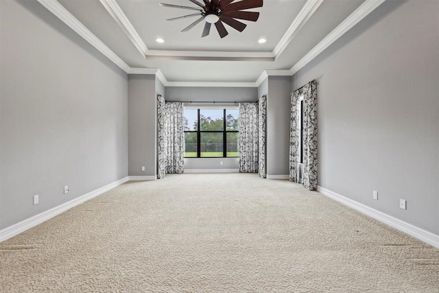 carpeted empty room with ornamental molding, recessed lighting, a raised ceiling, and baseboards