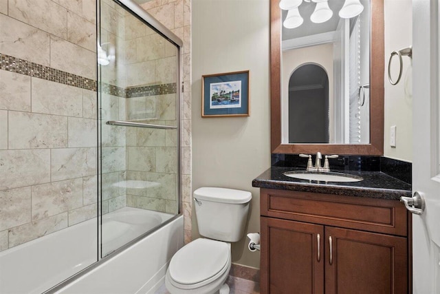 full bath featuring toilet, enclosed tub / shower combo, and vanity