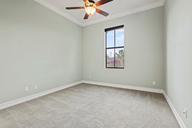 empty room featuring carpet floors, a ceiling fan, baseboards, and crown molding