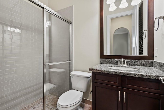 full bathroom with toilet, a stall shower, and vanity