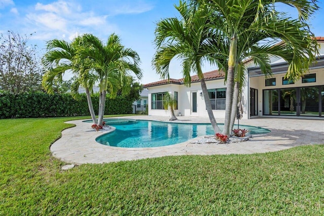 view of pool with a patio area, a fenced in pool, and a lawn