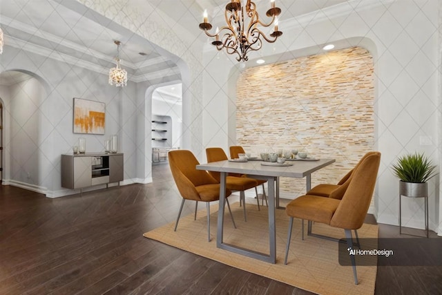 dining room with arched walkways, ornamental molding, wood finished floors, and a chandelier