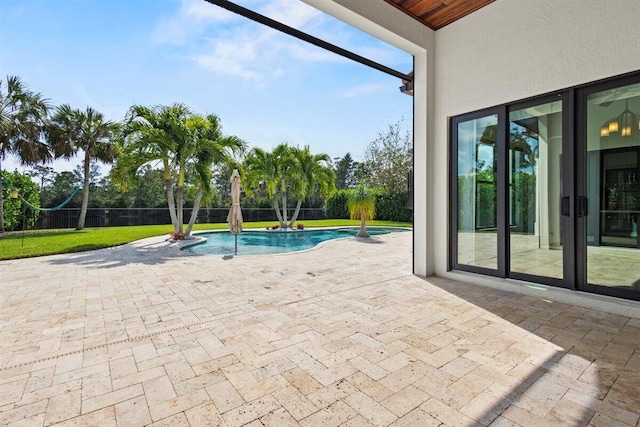 view of pool featuring a patio, a lanai, fence, a lawn, and a fenced in pool