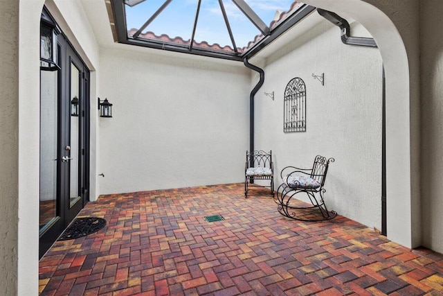 view of patio / terrace featuring glass enclosure