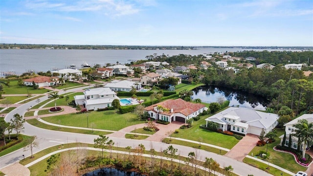 bird's eye view with a residential view and a water view