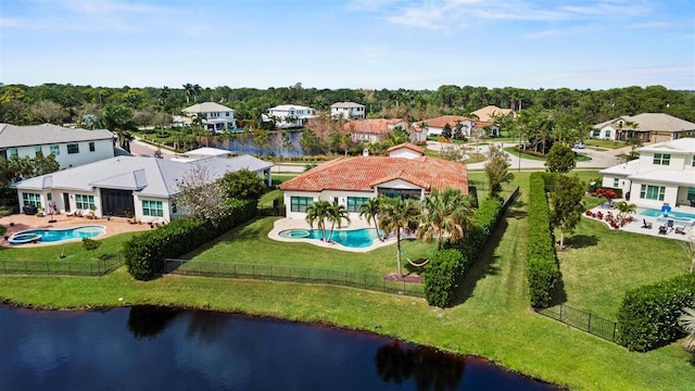 birds eye view of property with a water view and a residential view