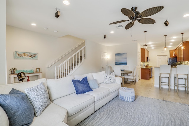 tiled living room featuring ceiling fan