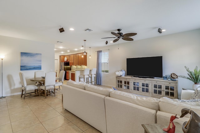 living room with ceiling fan and light tile patterned floors