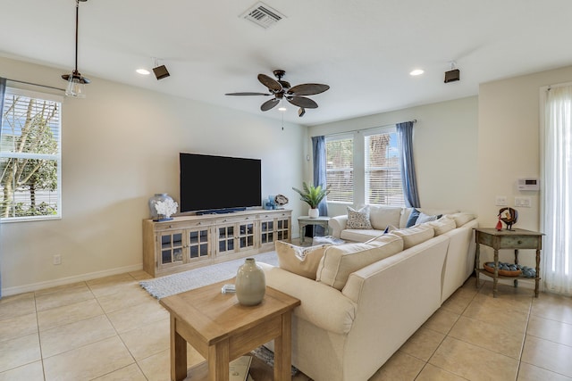 living room featuring ceiling fan, a healthy amount of sunlight, and light tile patterned floors