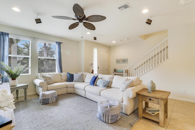 living room with light tile patterned floors and ceiling fan