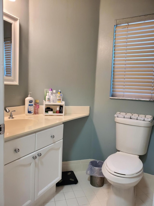 bathroom featuring toilet, tile patterned flooring, and vanity