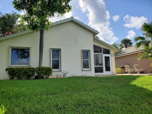 back of property with a lawn