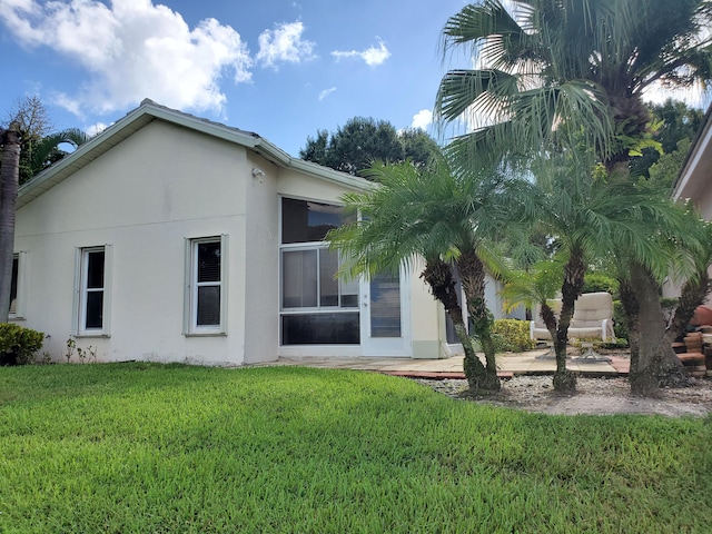 rear view of property with a patio area and a yard