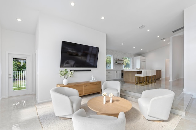 living room with recessed lighting, marble finish floor, and visible vents