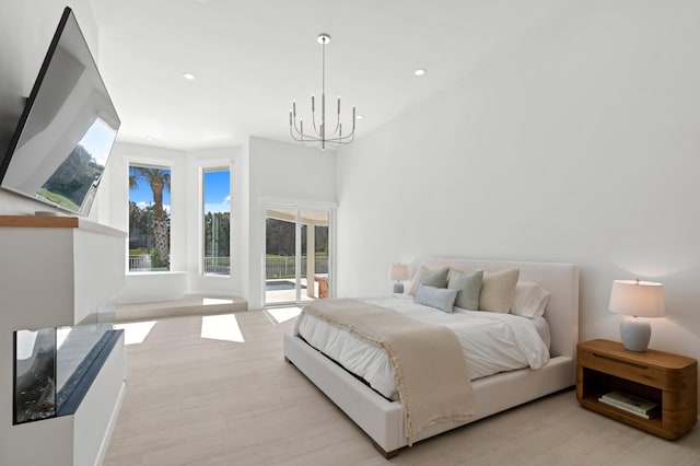 bedroom with a chandelier, access to outside, light wood-style flooring, and recessed lighting