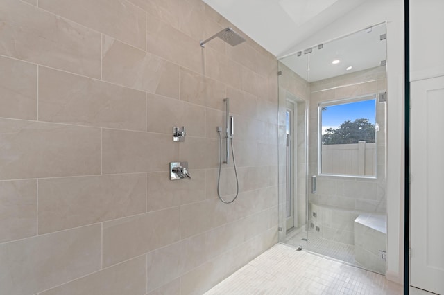 full bathroom with lofted ceiling and a shower stall