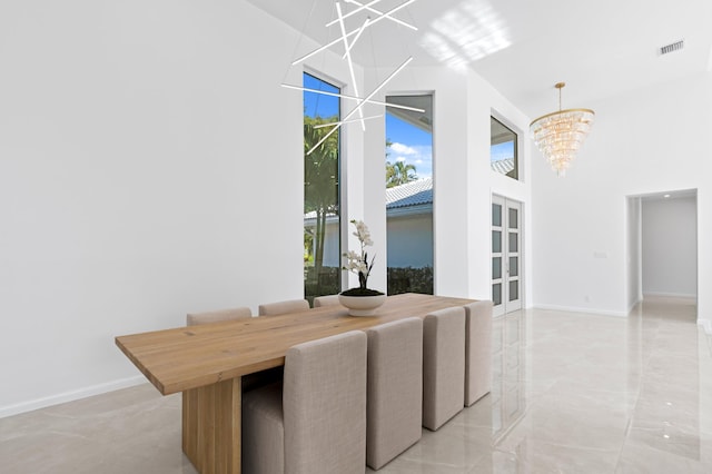 dining space featuring marble finish floor, visible vents, baseboards, and an inviting chandelier