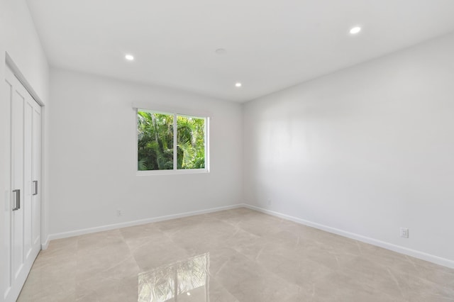 unfurnished bedroom with recessed lighting, a closet, and baseboards