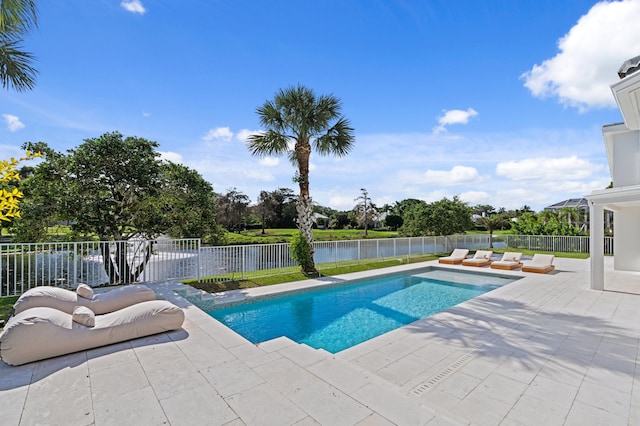 view of pool with a water view, a patio, and a fenced backyard