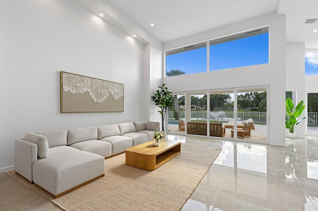 living area with recessed lighting, marble finish floor, visible vents, and baseboards