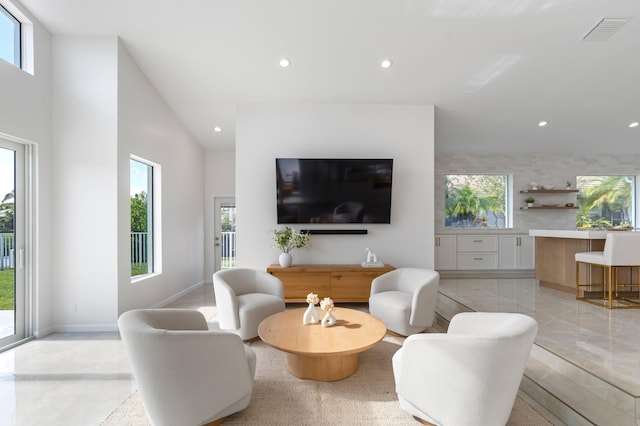 living area featuring a healthy amount of sunlight, visible vents, and recessed lighting