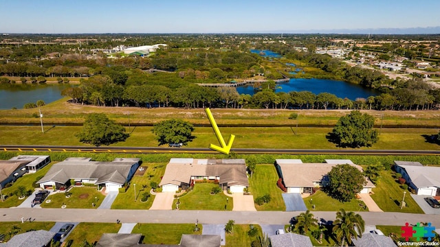 drone / aerial view featuring a residential view and a water view