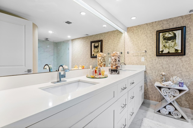 bathroom featuring wallpapered walls, visible vents, a sink, and recessed lighting