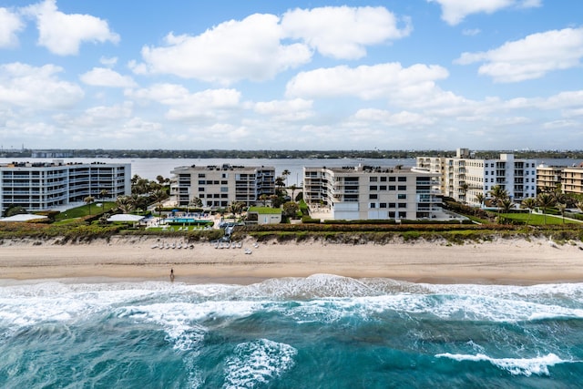 birds eye view of property with a water view and a view of the beach