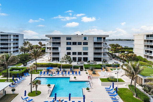 community pool featuring a water view and a patio