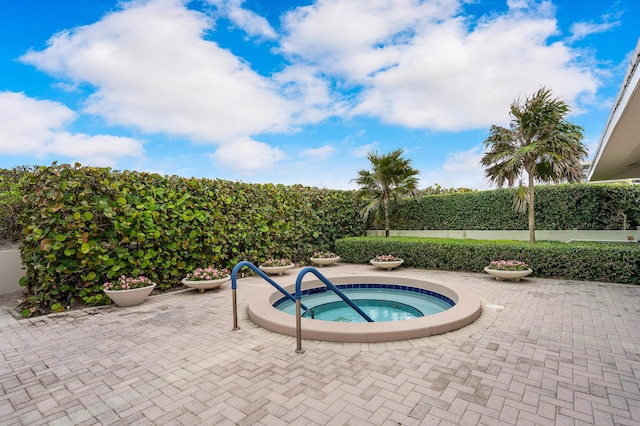 view of pool with a patio area and a hot tub