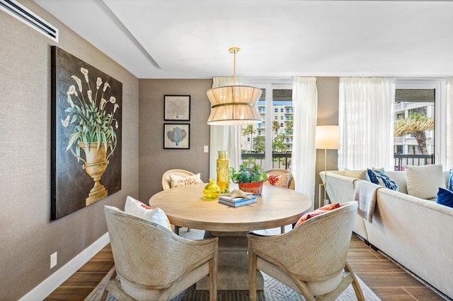 dining area featuring a wealth of natural light, visible vents, baseboards, and wood finished floors