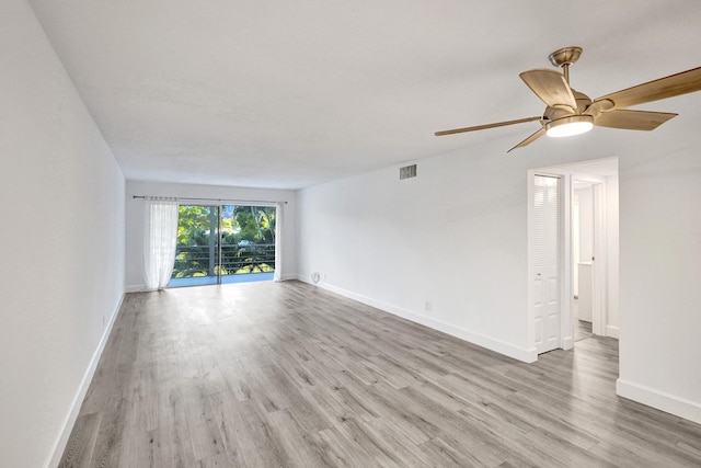 unfurnished room with light wood finished floors, visible vents, baseboards, and ceiling fan