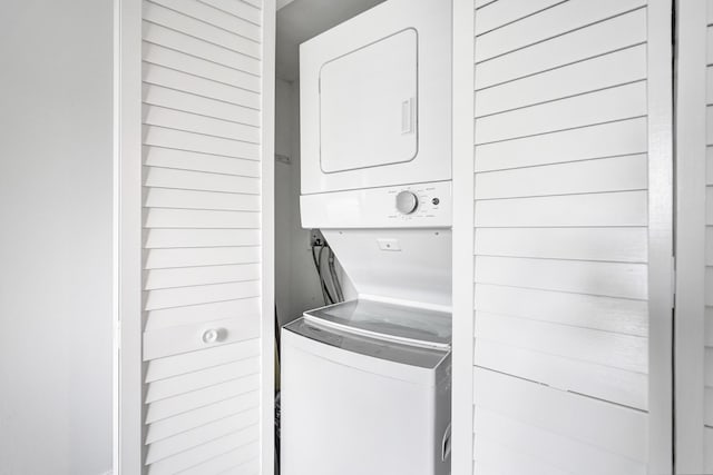 laundry room featuring stacked washing maching and dryer and laundry area