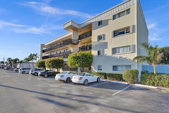 view of building exterior featuring uncovered parking