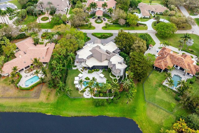 drone / aerial view featuring a residential view and a water view