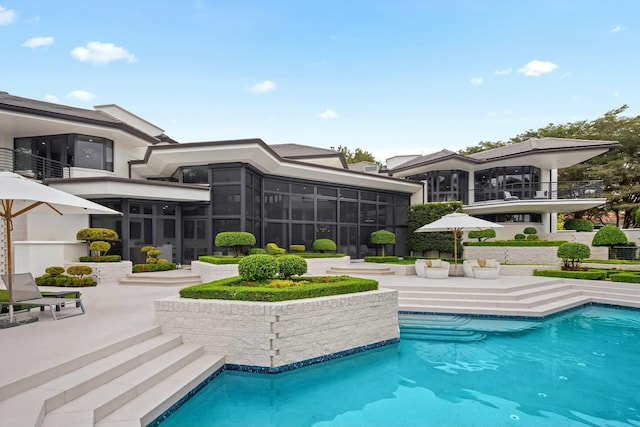 pool featuring a sunroom