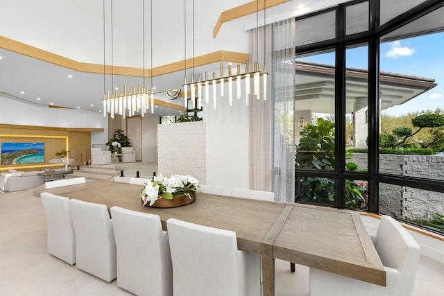 dining space with a wall of windows and recessed lighting