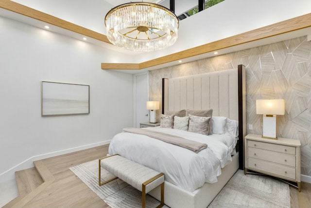 bedroom with recessed lighting, baseboards, an inviting chandelier, and wood finished floors
