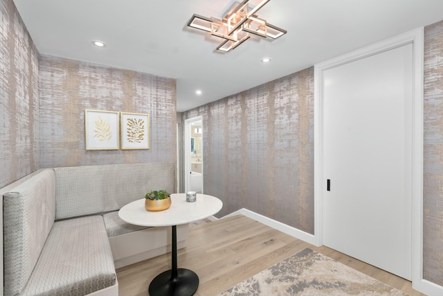 dining room featuring a chandelier, recessed lighting, breakfast area, and wood finished floors