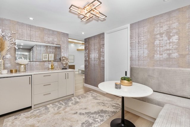 bathroom with backsplash, recessed lighting, vanity, and wood finished floors