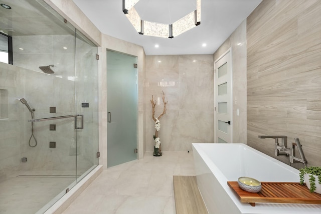 bathroom featuring a stall shower, a soaking tub, recessed lighting, and tile walls