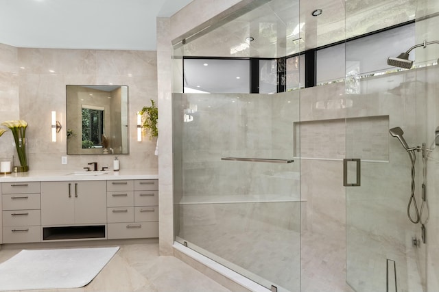 bathroom featuring a stall shower, tile walls, and vanity