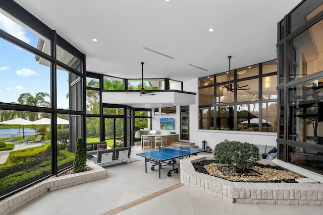sunroom / solarium with ceiling fan, outdoor dining area, tile patterned flooring, and recessed lighting